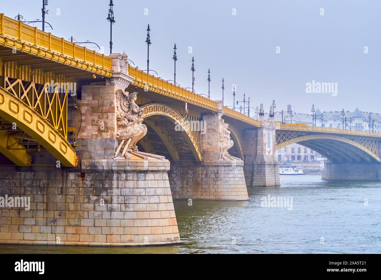 The bas-relief statues of Ancient Gods on the stone pillars of Margaret Bridge, Budapest, Hungary Stock Photo