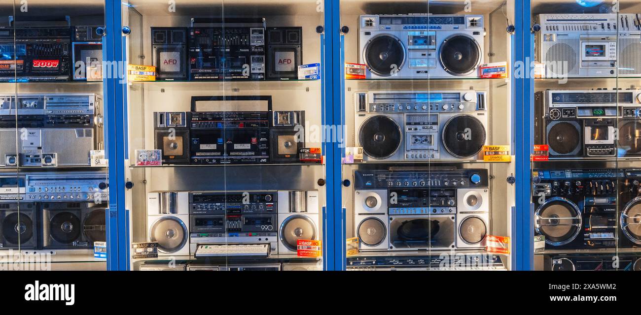 various classic Japanese vintage cassette recorders, portable boomboxes and tape audio cassettes on the museum shelf. Tashkent, Uzbekistan - April 16, 2024 Stock Photo