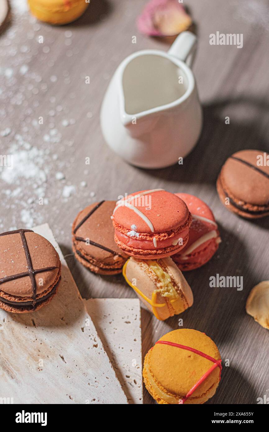Colorful macarons and assorted sweets displayed on a table Stock Photo