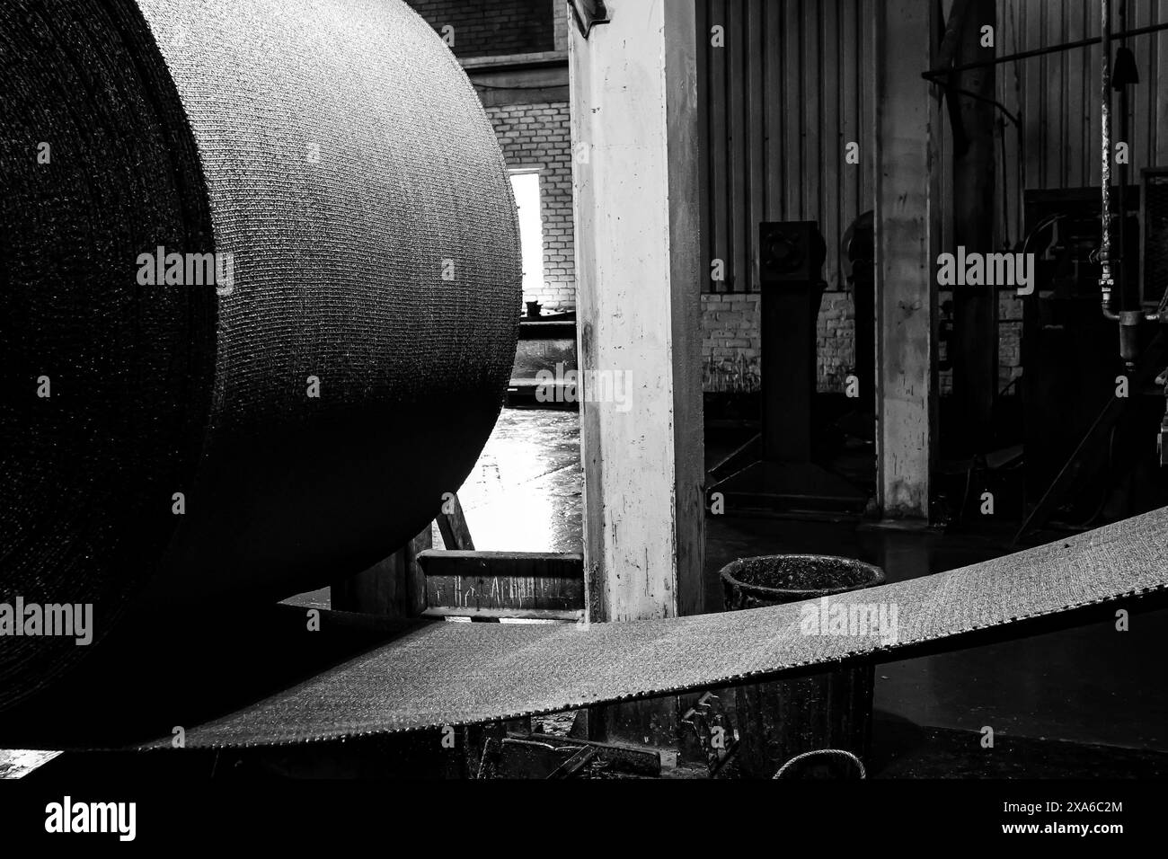 A closeup of rubber roll on conveyor belt machinery at a factory in Johannesburg, South Africa