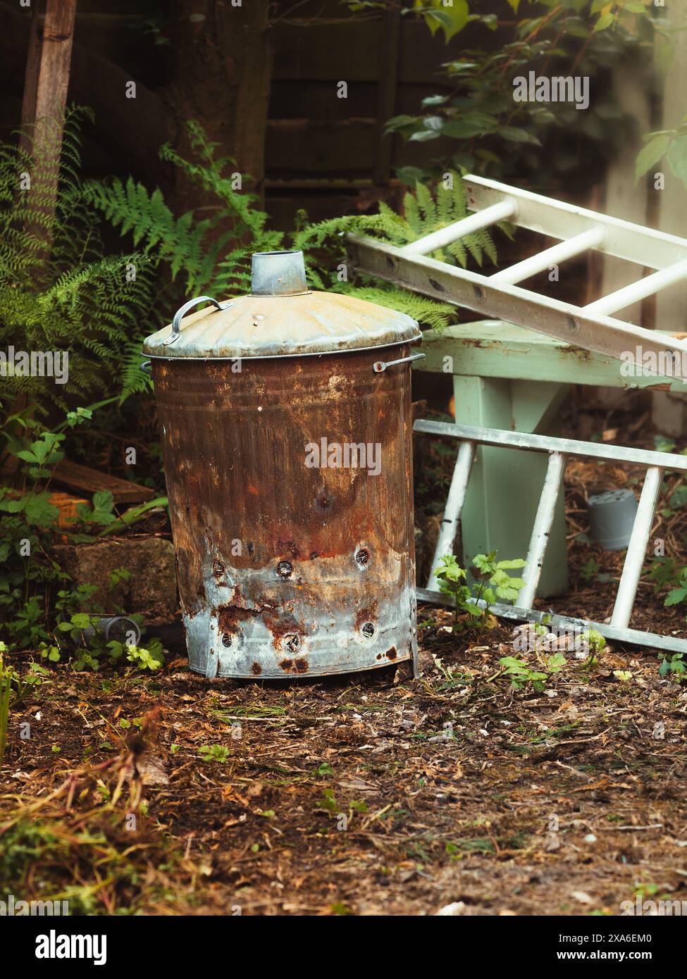 The garden incinerator steel bin for burning waste material Stock Photo
