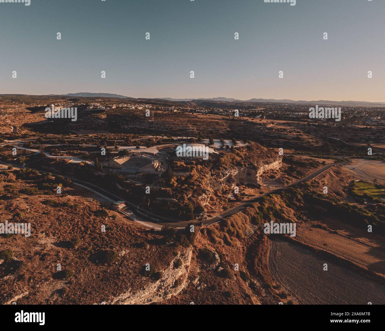 Aerial view of sunset over farm and dirt hills inKourion Amphitheater ...
