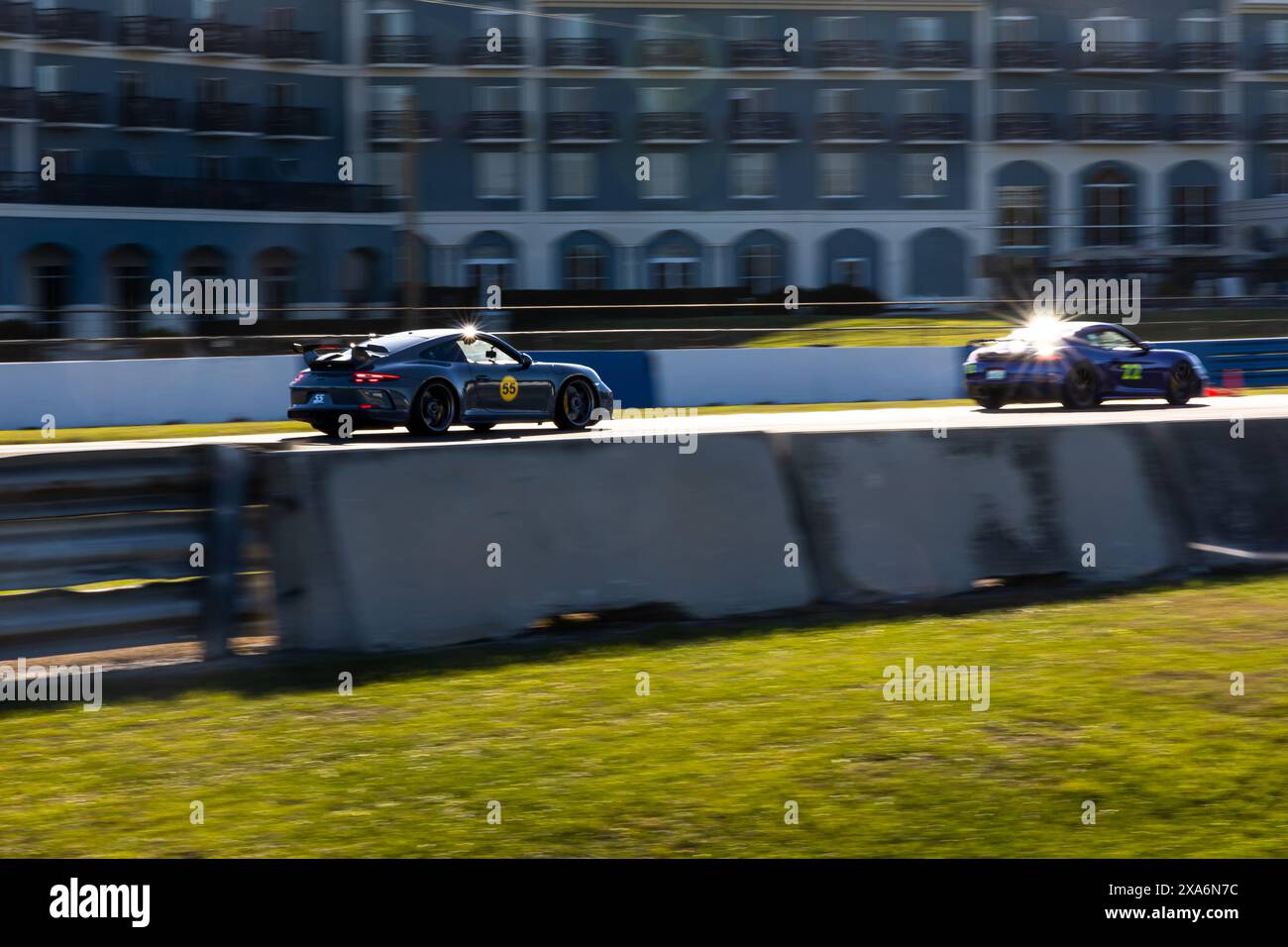 The two Porsche racing cars speeding on the Sebring track in the USA ...