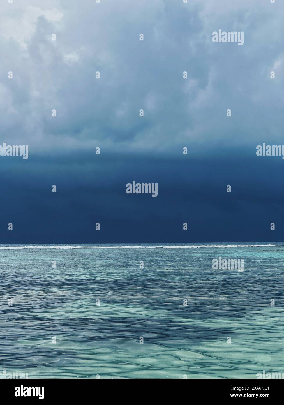 Dramatic dark skies over the light blue ocean Stock Photo - Alamy