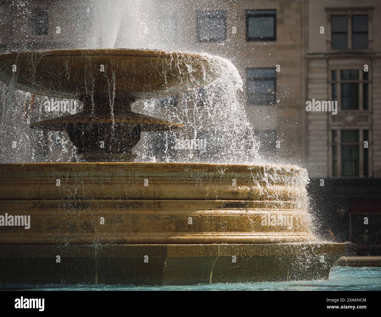 A building with a water fountain splashing water. Stock Photo