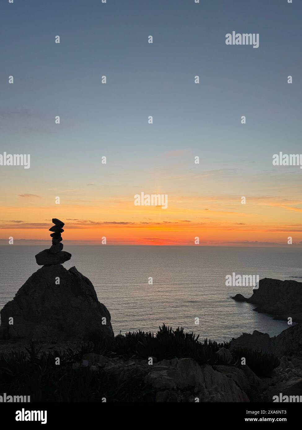 A sculpture set against Cargese's picturesque sunset on the island of Corsica Stock Photo