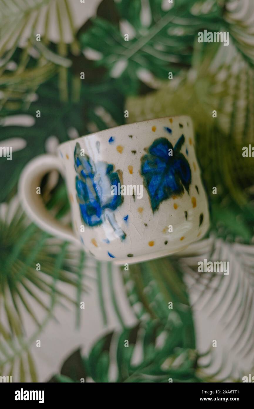 The beautiful hand-made ceramic mug displayed on the table Stock Photo