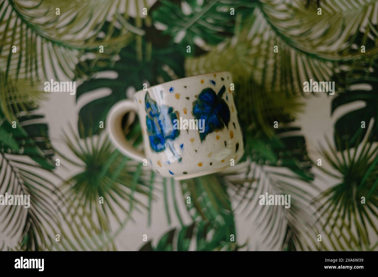 The beautiful hand-made ceramic mug displayed on the table Stock Photo