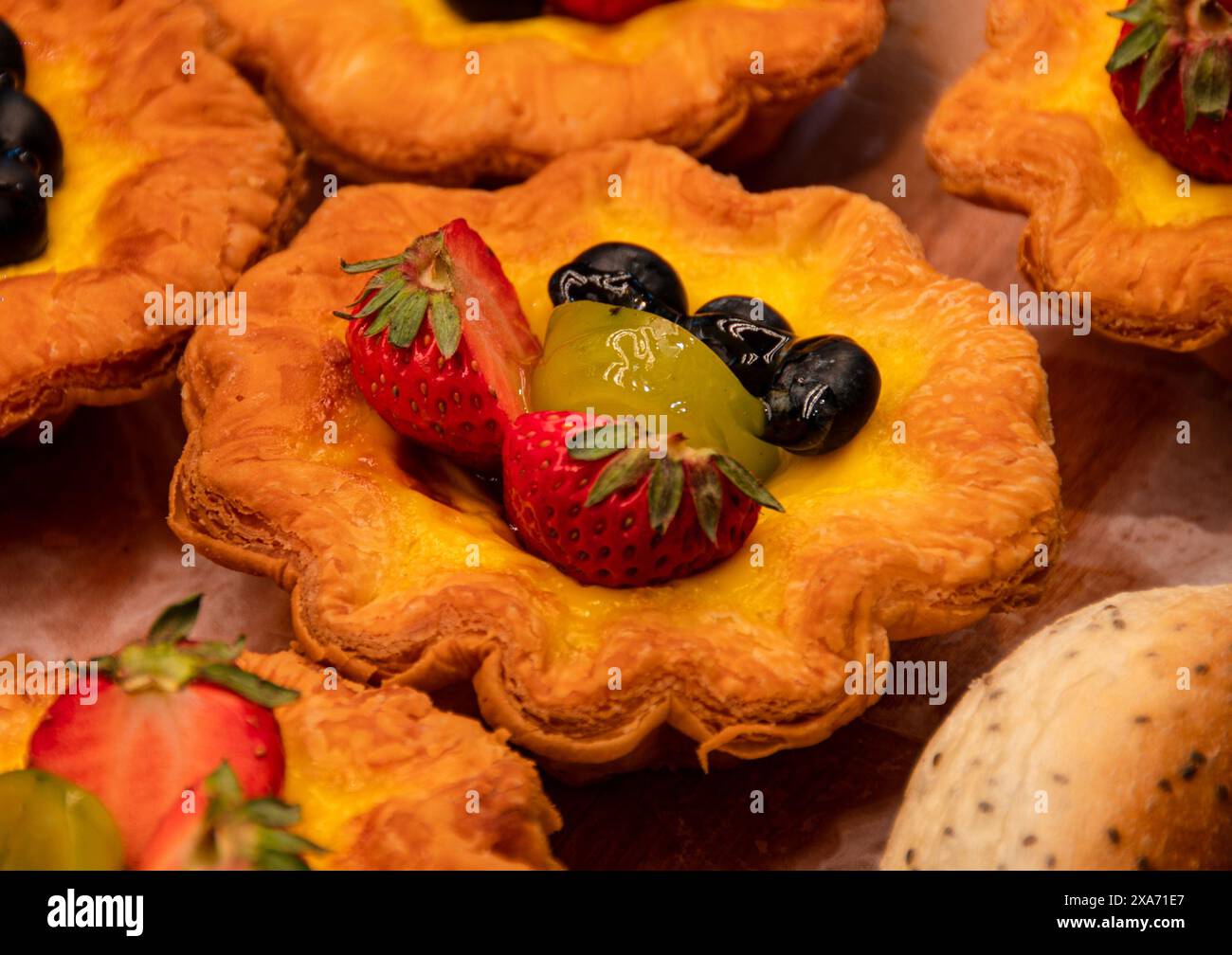 Assorted fruit tarts on a table setting Stock Photo