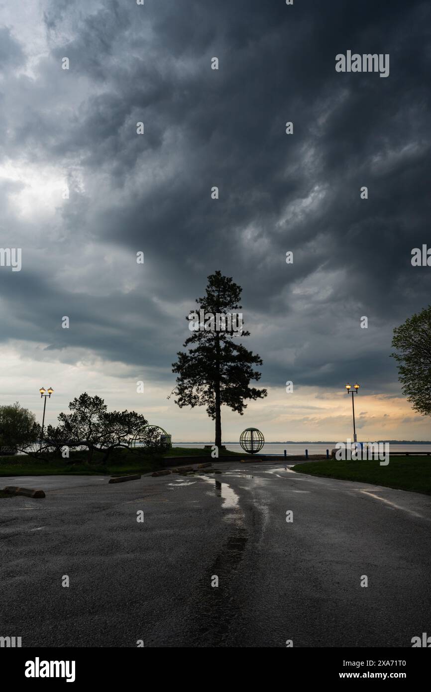 The Dramatic clouds rolling over sunset at Couchiching Beach Park Stock Photo