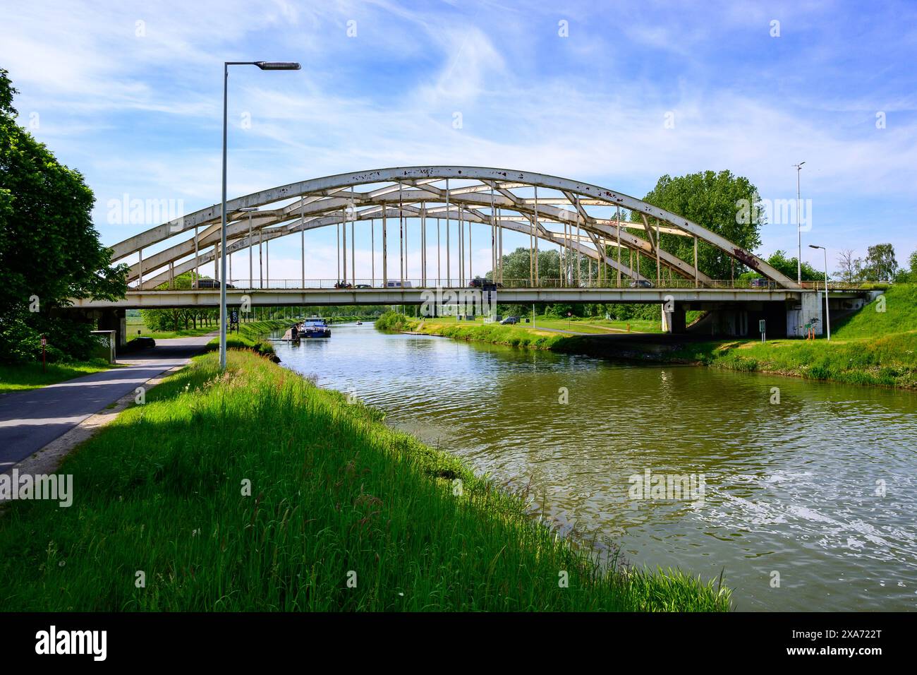 a metal curved bridge over the Netekanaal in Viersel, Belgium. Stock Photo