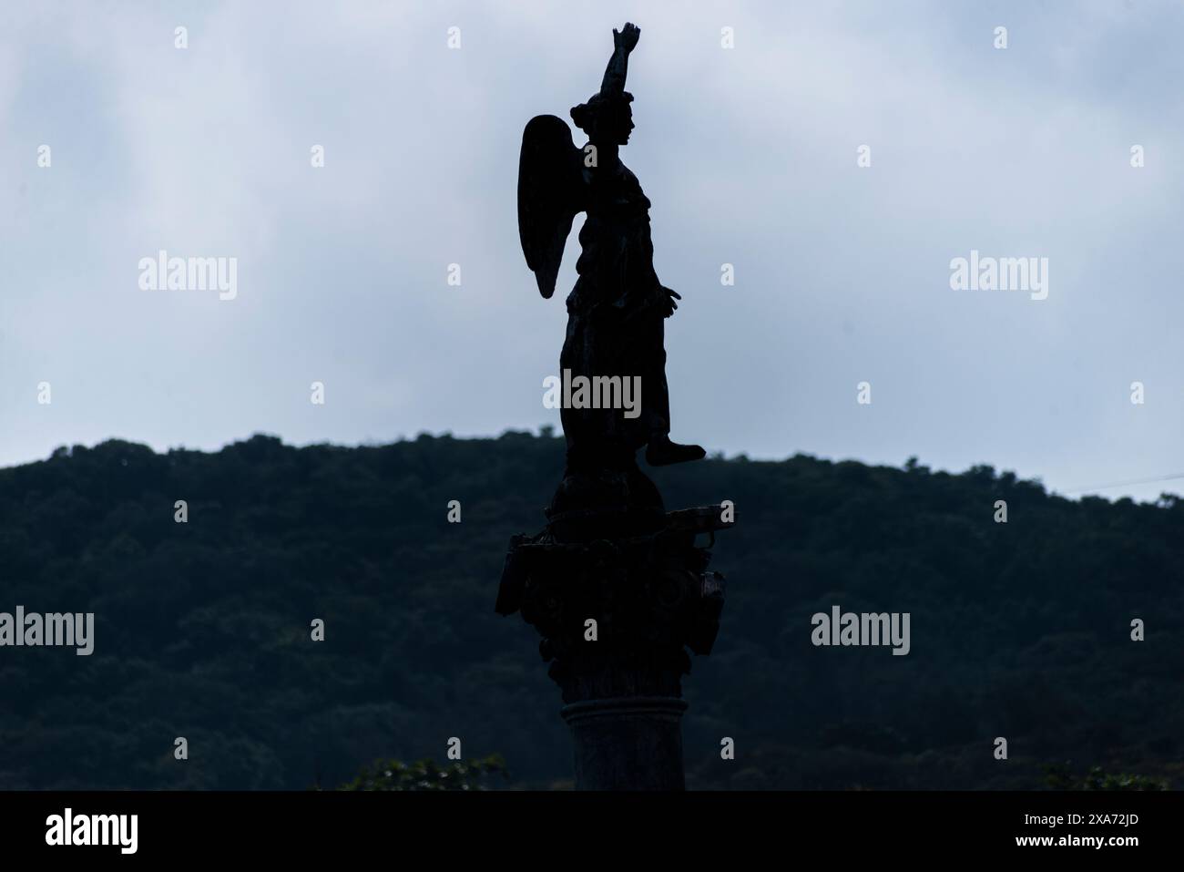 Angel statue atop urban street intersection Stock Photo