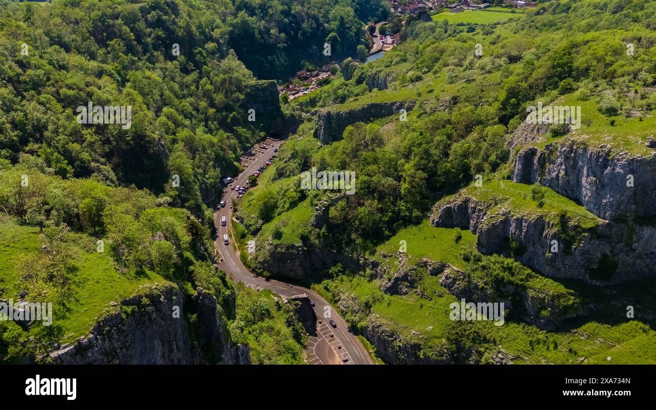 Green mountains with a winding road and a few people Stock Photo