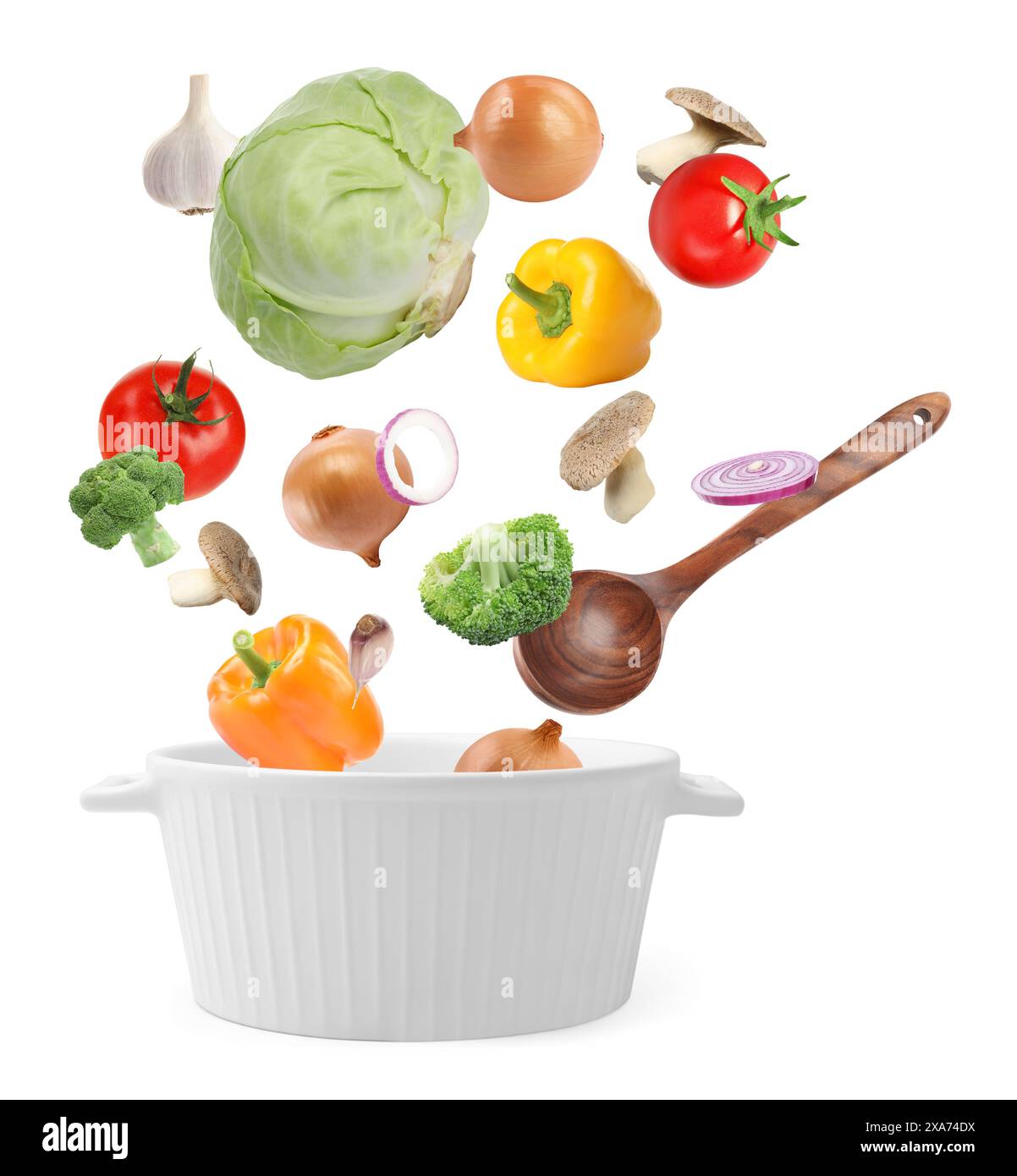 Fresh ingredients falling into saucepan on white background Stock Photo