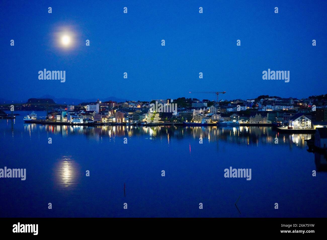 A nighttime view of the inner harbor of the city of Kristiansund, Norway. Stock Photo