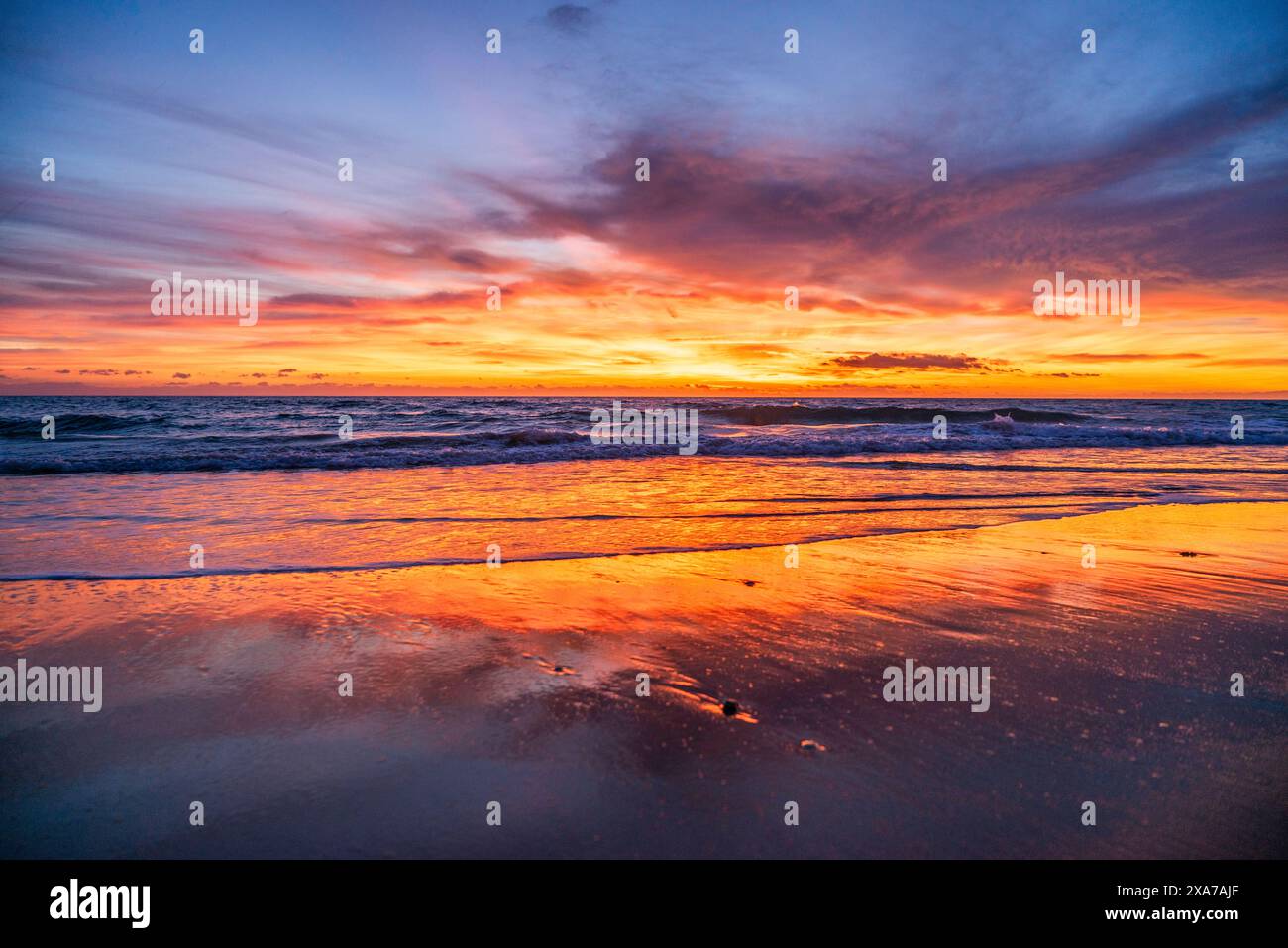 Sunset at sea with cloudy sky Stock Photo