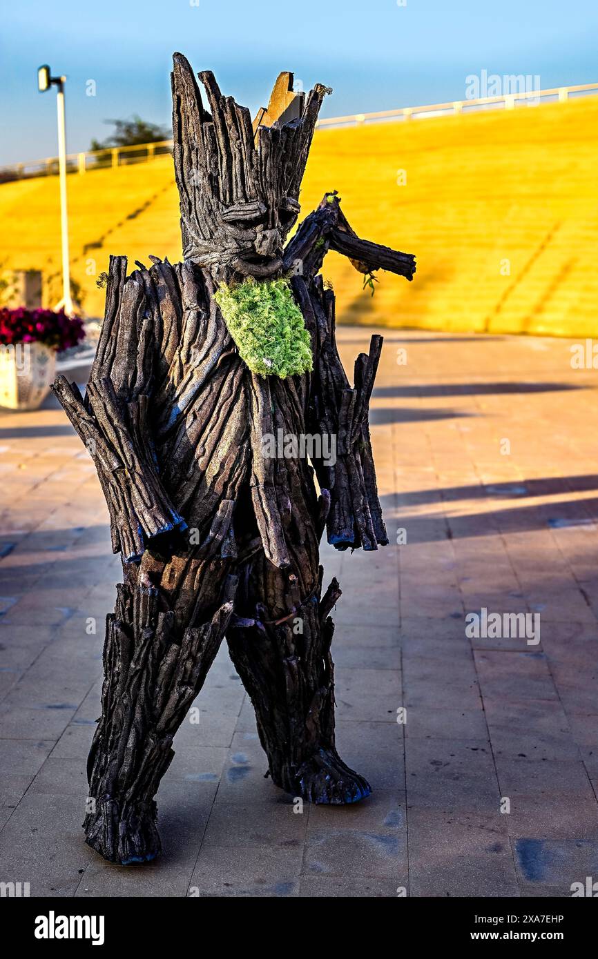 A man in a costume posing with hands clasped Stock Photo
