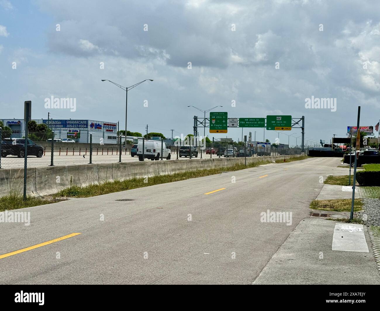 A highway with heavy traffic and overhead signs Stock Photo