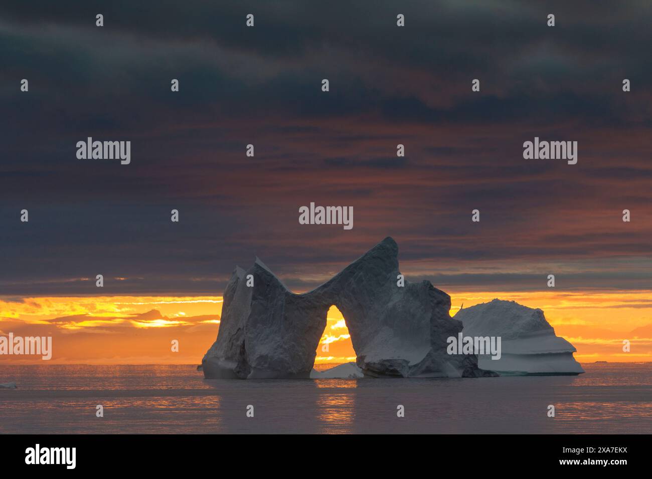 Iceberg with archway at sunset, Kangia Icefjord, UNESCO World Heritage ...