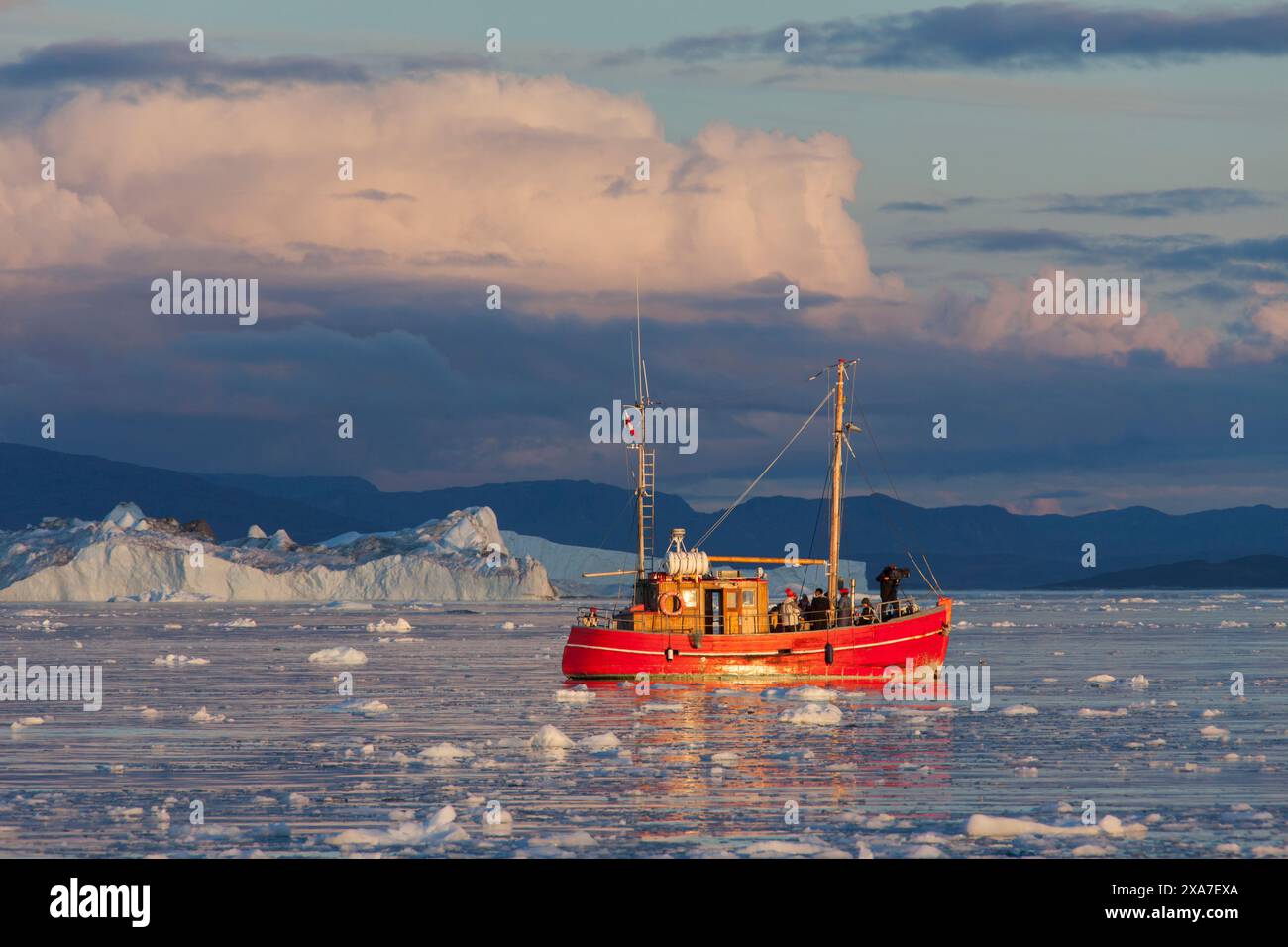 Tourist boat in front of icebergs, Kangia Icefjord, Disko Bay, UNESCO World Heritage Site, West Greenland, Greenland Stock Photo