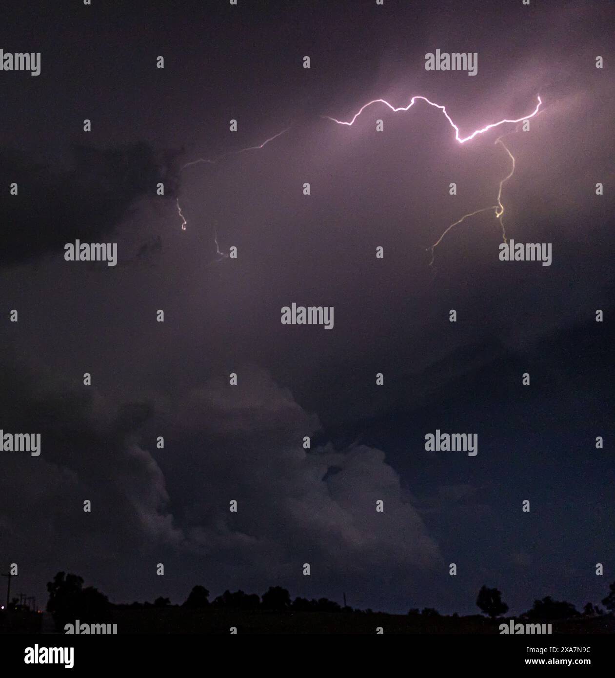 Lightning strikes across the night sky Stock Photo
