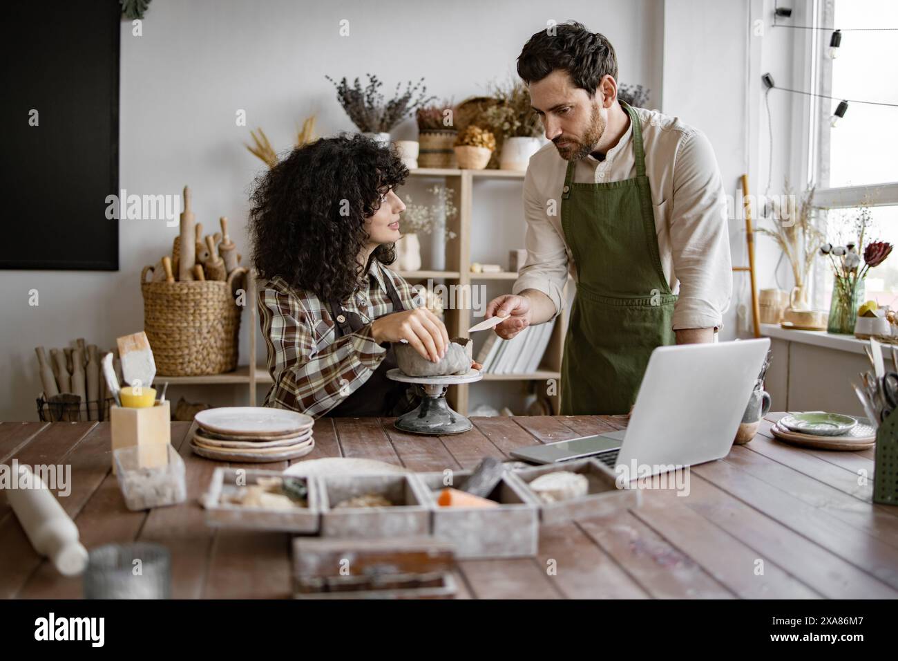 Pottery class with male and female artists working together Stock Photo ...