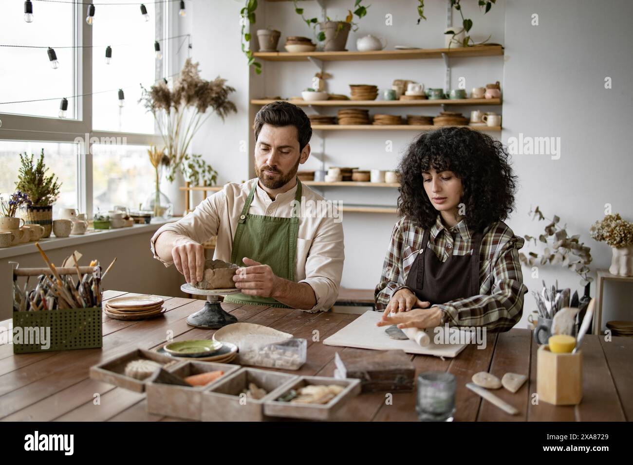 Bearded mature man woman sculpting hi-res stock photography and images ...