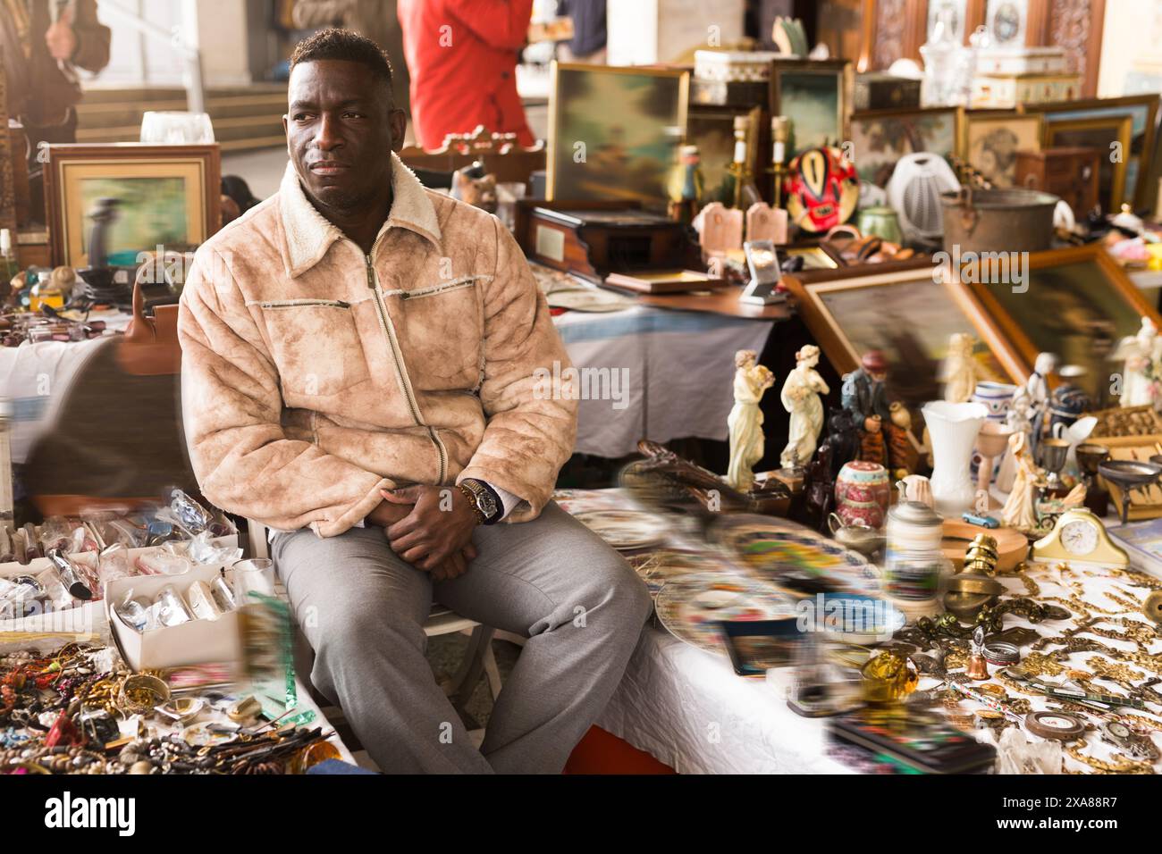 Ordinary african american guy sells things at a flea market Stock Photo