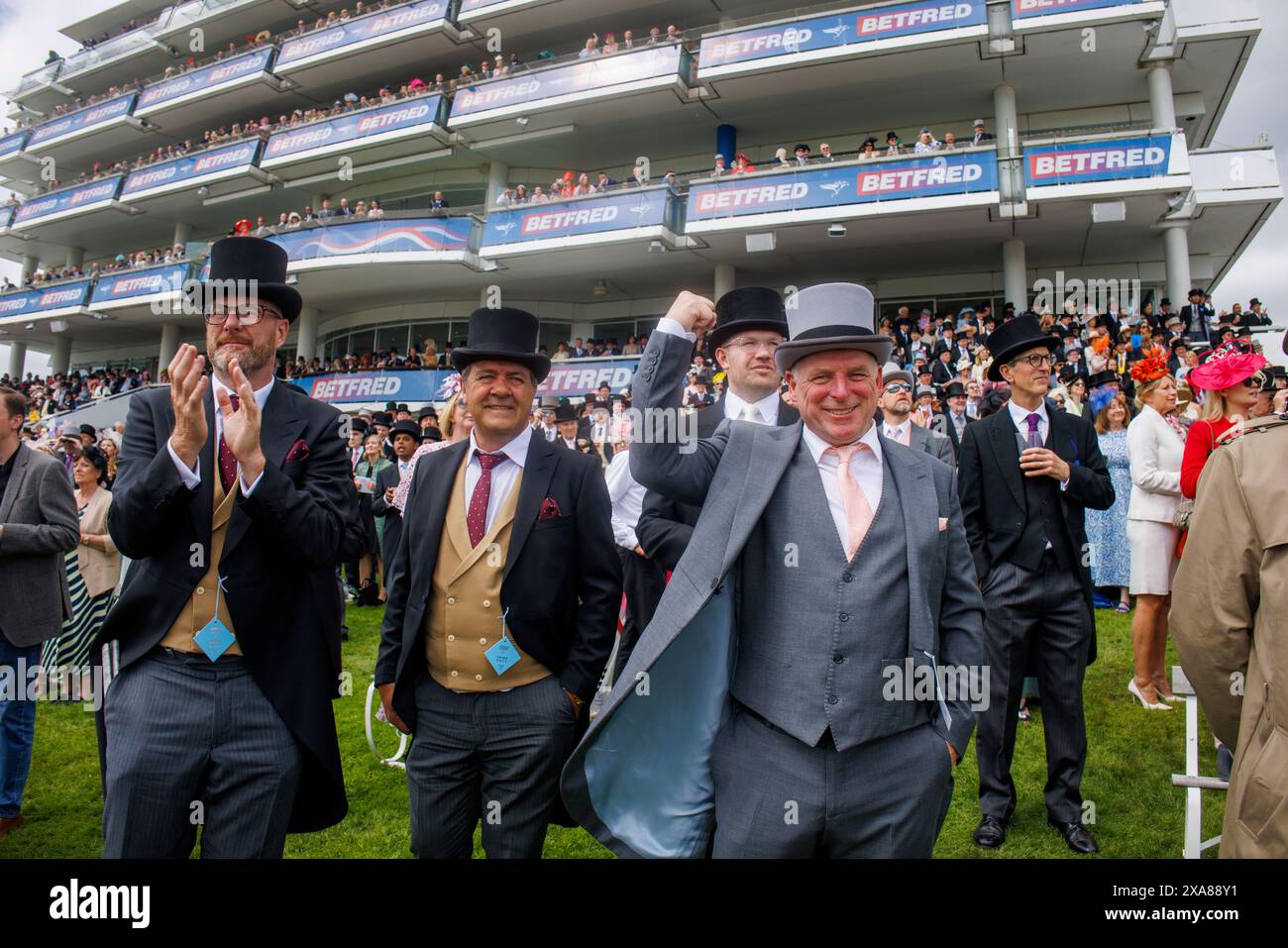 Three men in Top Hats cheer their horse on Derby day at Epsom race ...