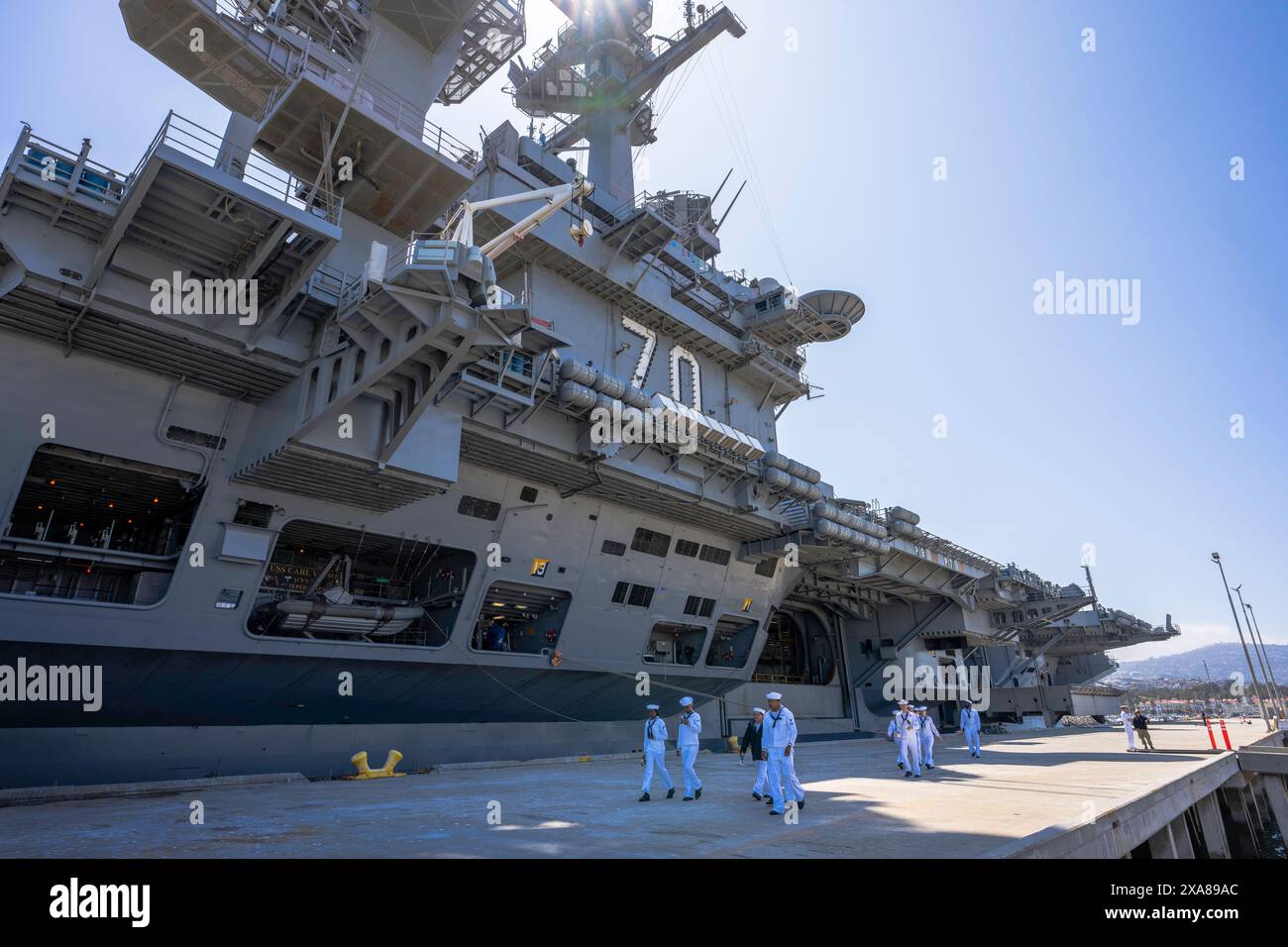 United States Navy Aircraft Carrier  -  Los Angeles, California - United States - 27 May 2024 -  USS Carl Vinson (CVN 70) - sailors walk by Stock Photo