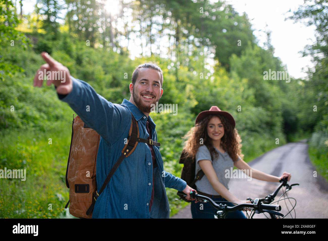 Travellers couple going on e-bike ride in nature. Tourist riding ...