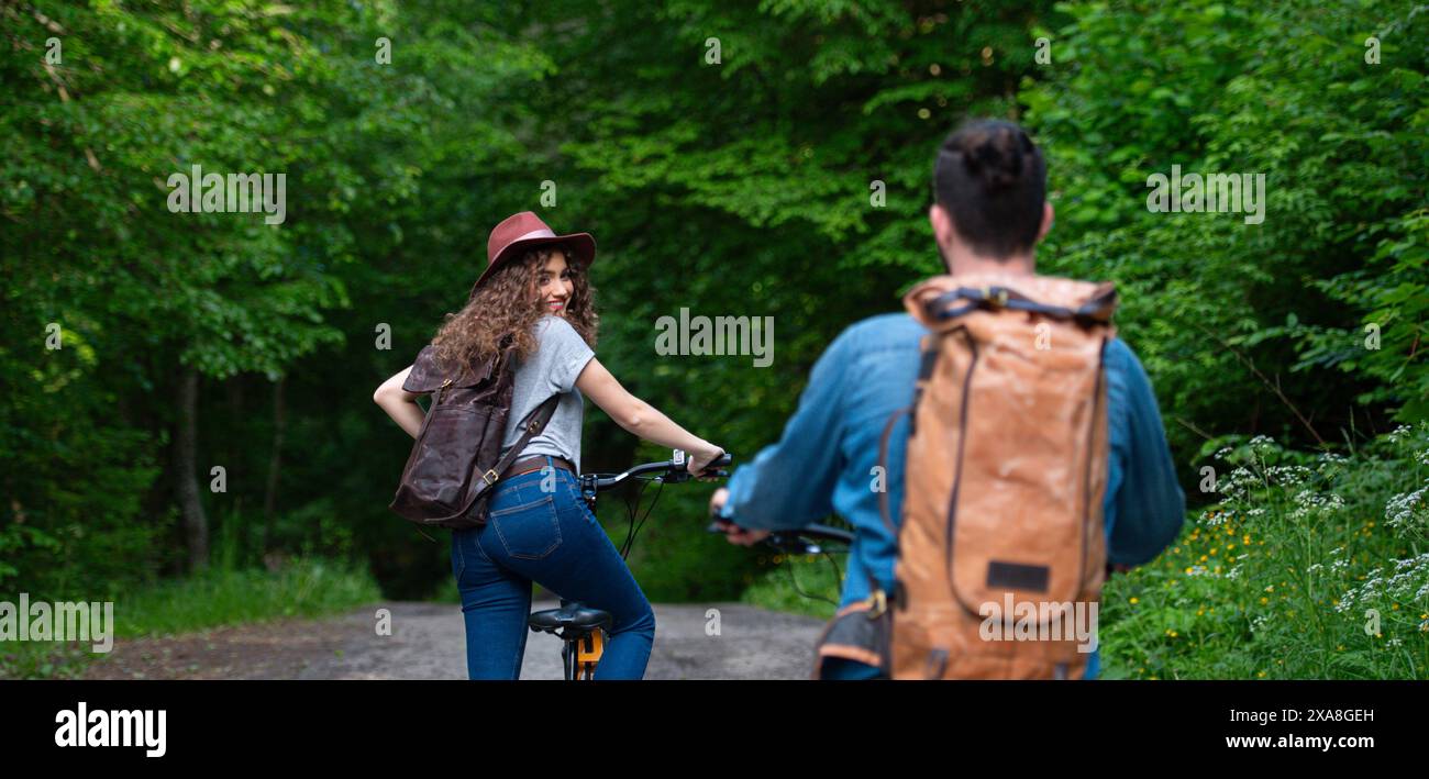 Travellers couple going on e-bike ride in nature. Tourist riding ...