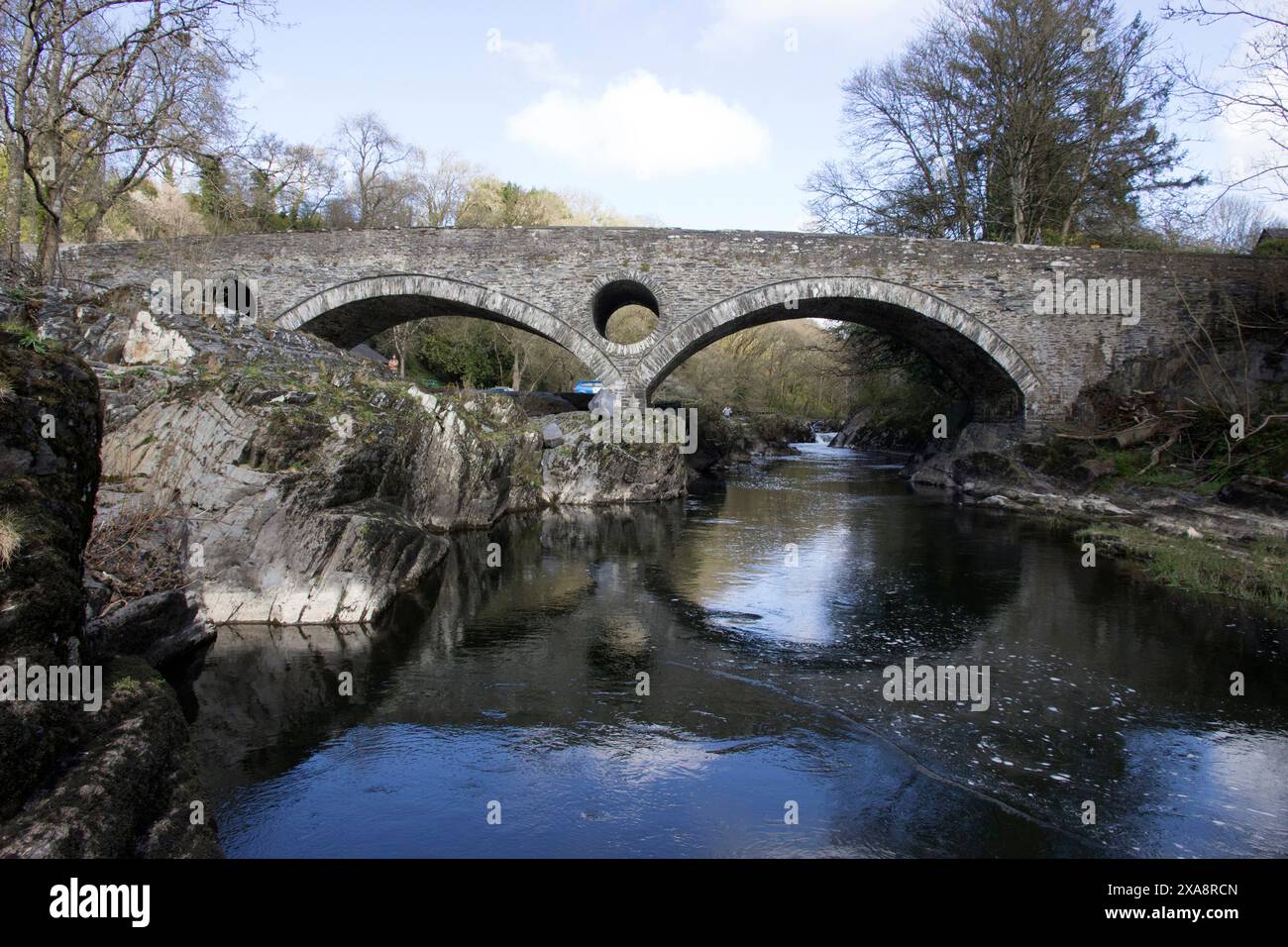 Cenarth Bridge is a single-carriageway three-arch rubble road bridge crossing the river Teifi, built by David Edwards in 1785-7. Stock Photo