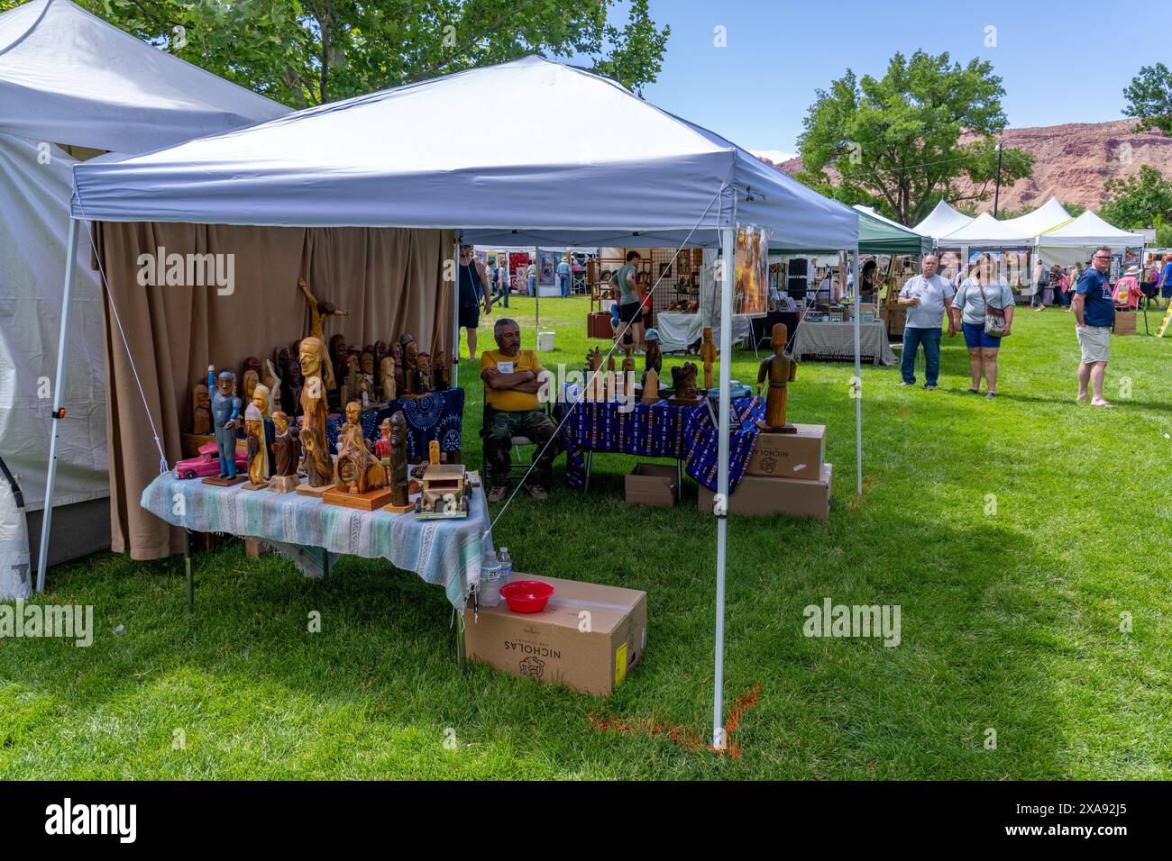A woodcarver sells his work at the annual Moab Arts Festival in Moab