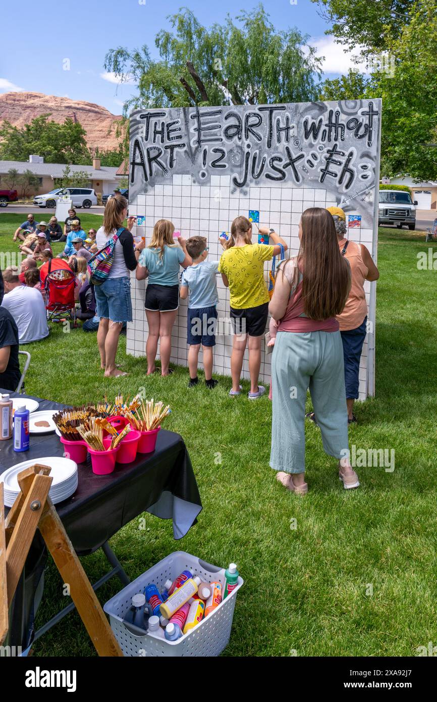 Kids painting on a mural at the annual Moab Arts Festival in Moab, Utah