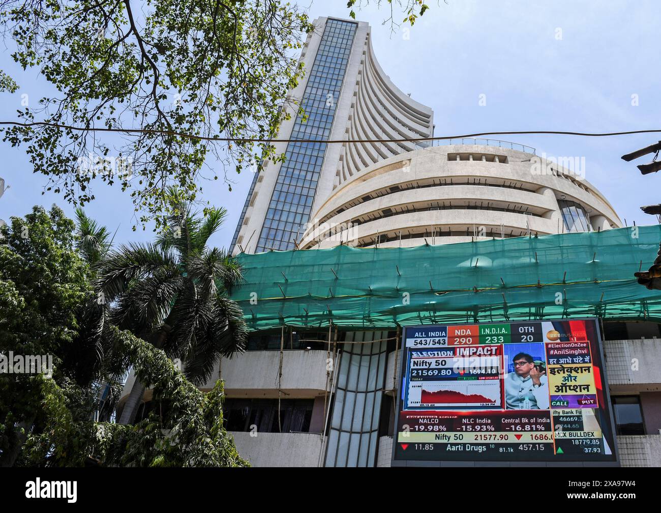 A billboard displaying the Election results outside the Bombay Stock Exchange (BSE) building. The stock market was volatile when it opened in the morning due to election result, there was an anticipation of Bharatiya Janata Party (BJP) getting the majority of the votes and Prime Minister Narendra Modi getting elected for the third time, but that wasn't the case as opposition parties gave tough fight to the Bharatiya Janata Party (BJP) as votes were being counted and result was flashed on the screen which impacted the stock trading heavily. Stock Photo