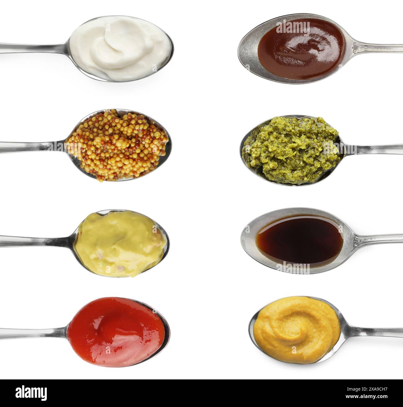 Set of different sauces in spoons isolated on white, top view Stock Photo