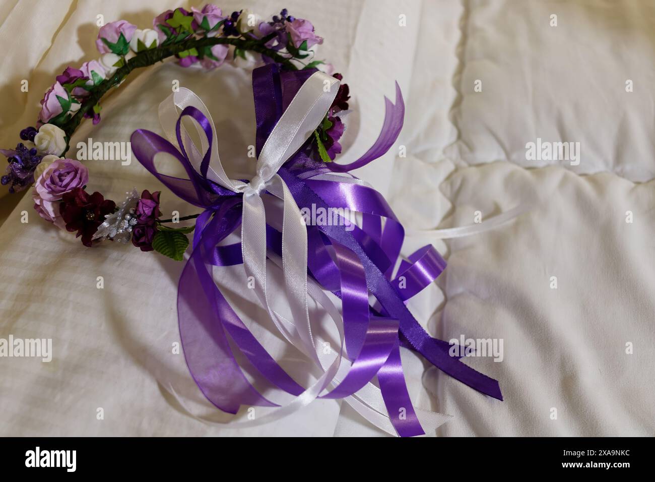 Floral crown adorned with purple and white ribbons and flowers Stock ...