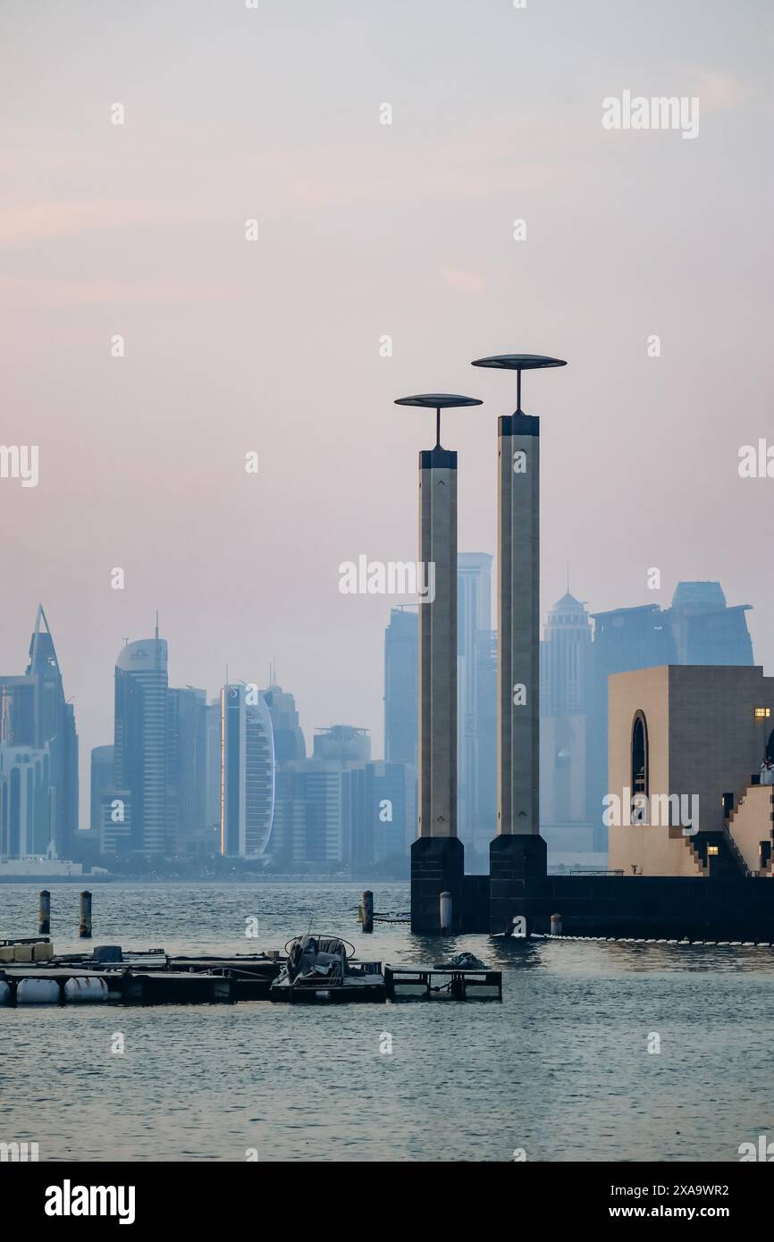The embankments of the Persian Gulf in the center of Doha at sunset Stock Photo