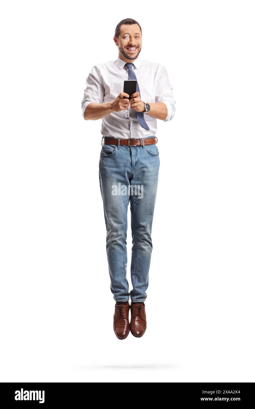 Happy businessman using a smartphone and jumping isolated on white ...