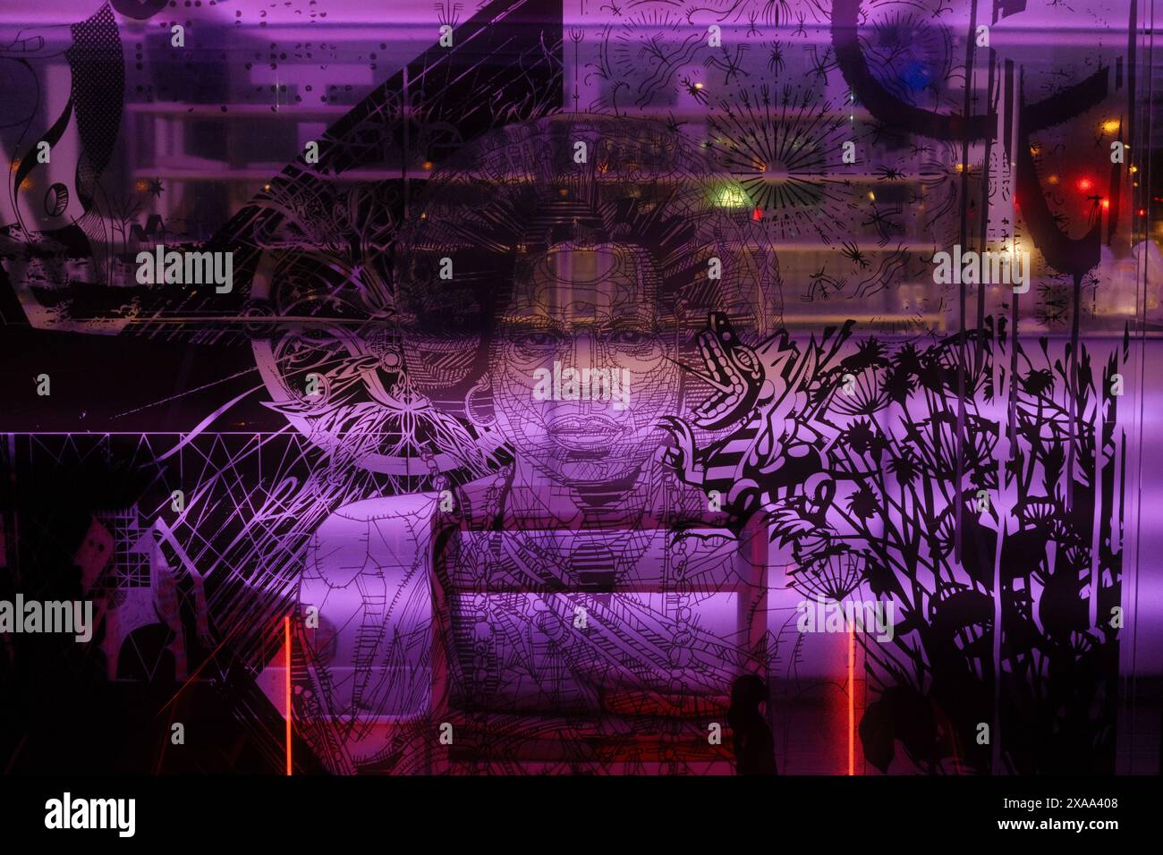 A dark purple graffiti on a Parisian wall Stock Photo