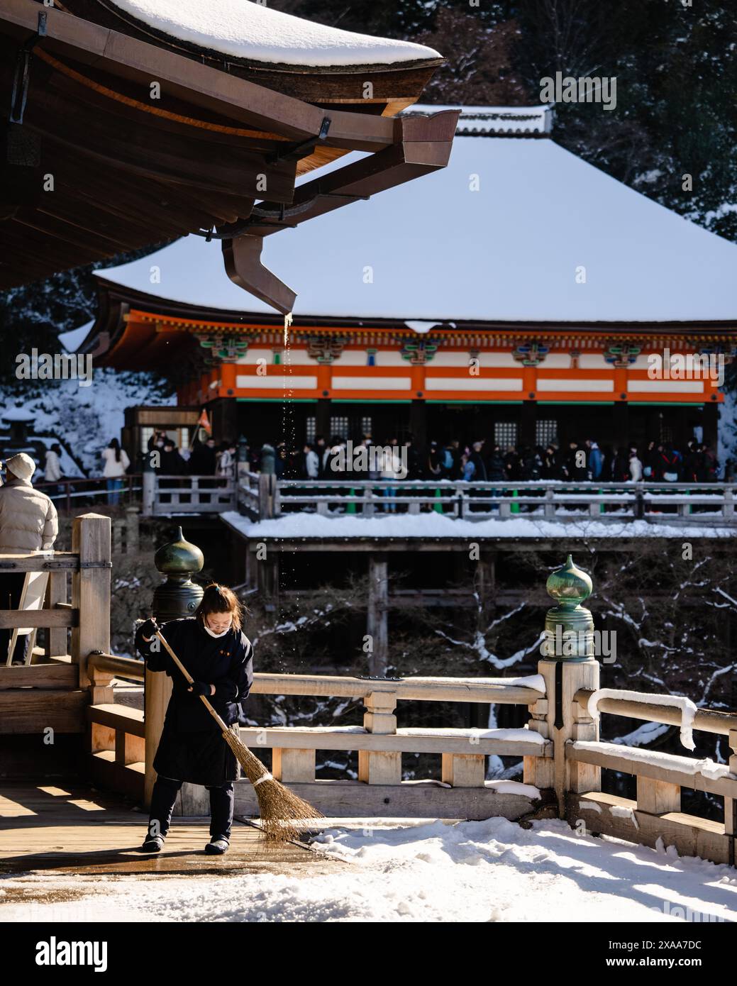 Sweeping Platform A Japanese woman sweeping off snow-covered platform in the ancient ...