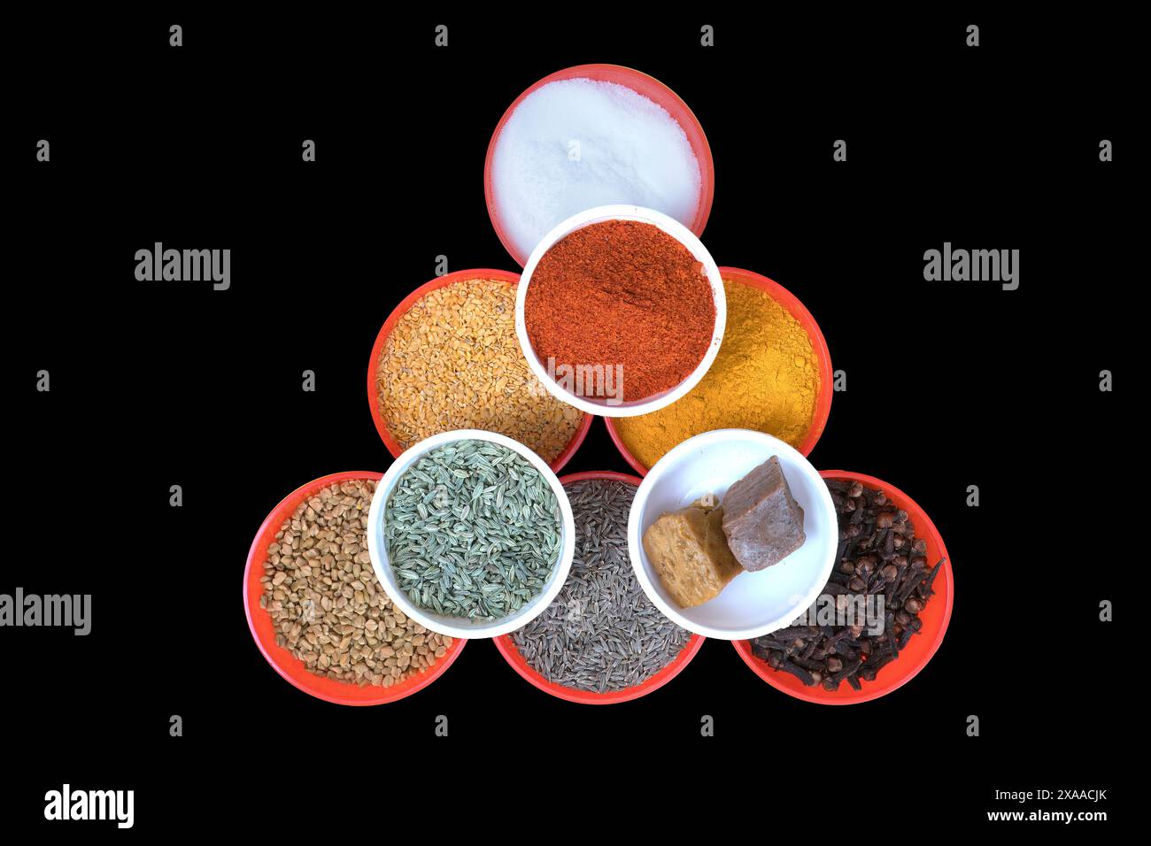 small white bowls filled with salt, Fenugreek Seeds, turmeric powder ...