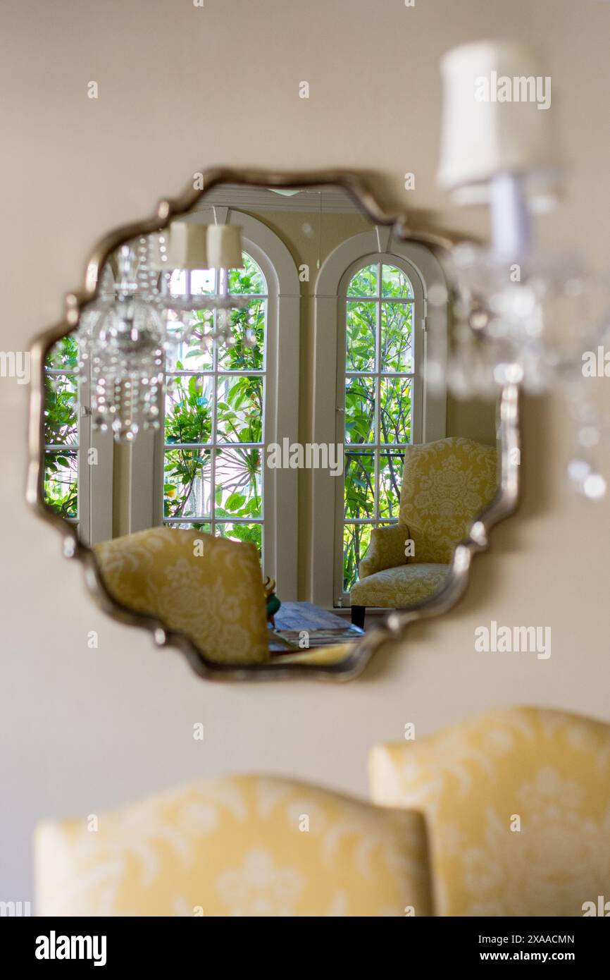 A mirror hanging on dining room wall Stock Photo - Alamy