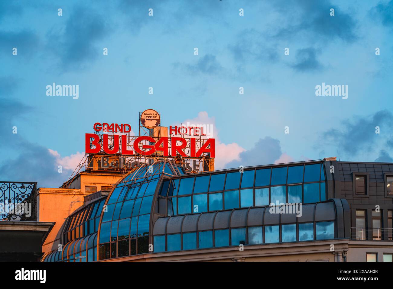 Sofia, Bulgaria. May 23, 2024. Grand Hotel Bulgaria Sign at Sunset in Sofia. Text Translation: Balkan Tourism Stock Photo