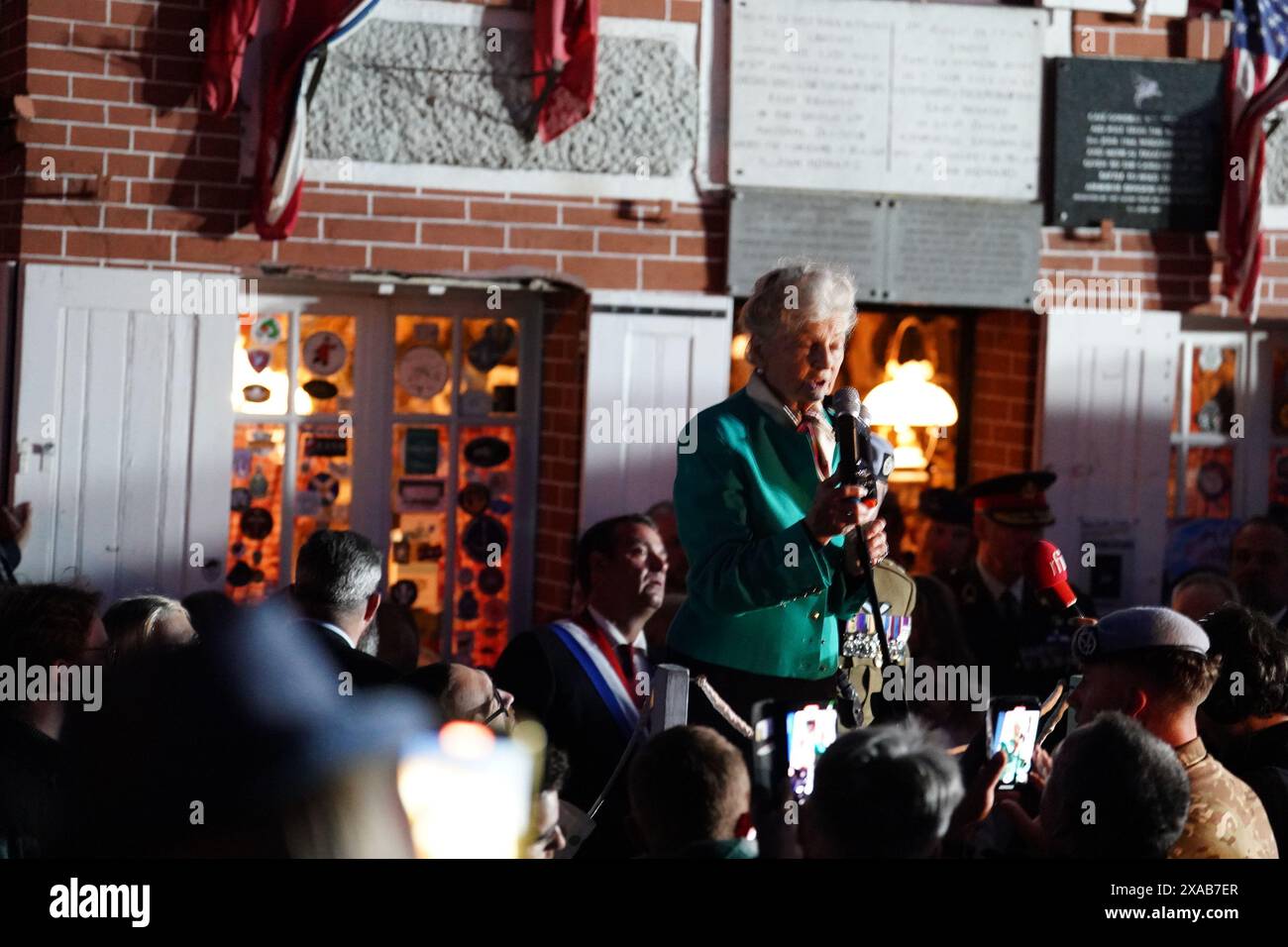 84-year-old Arlette Gondree speaking before giving a champagne toast to D-Day veterans at 2316 in the evening, marking the exact moment 80 years ago that British troops entered her family's cafe in Benouville, Normandy, France, making them the first family to be liberated from German control. Picture date: Wednesday June 5, 2024. Stock Photo