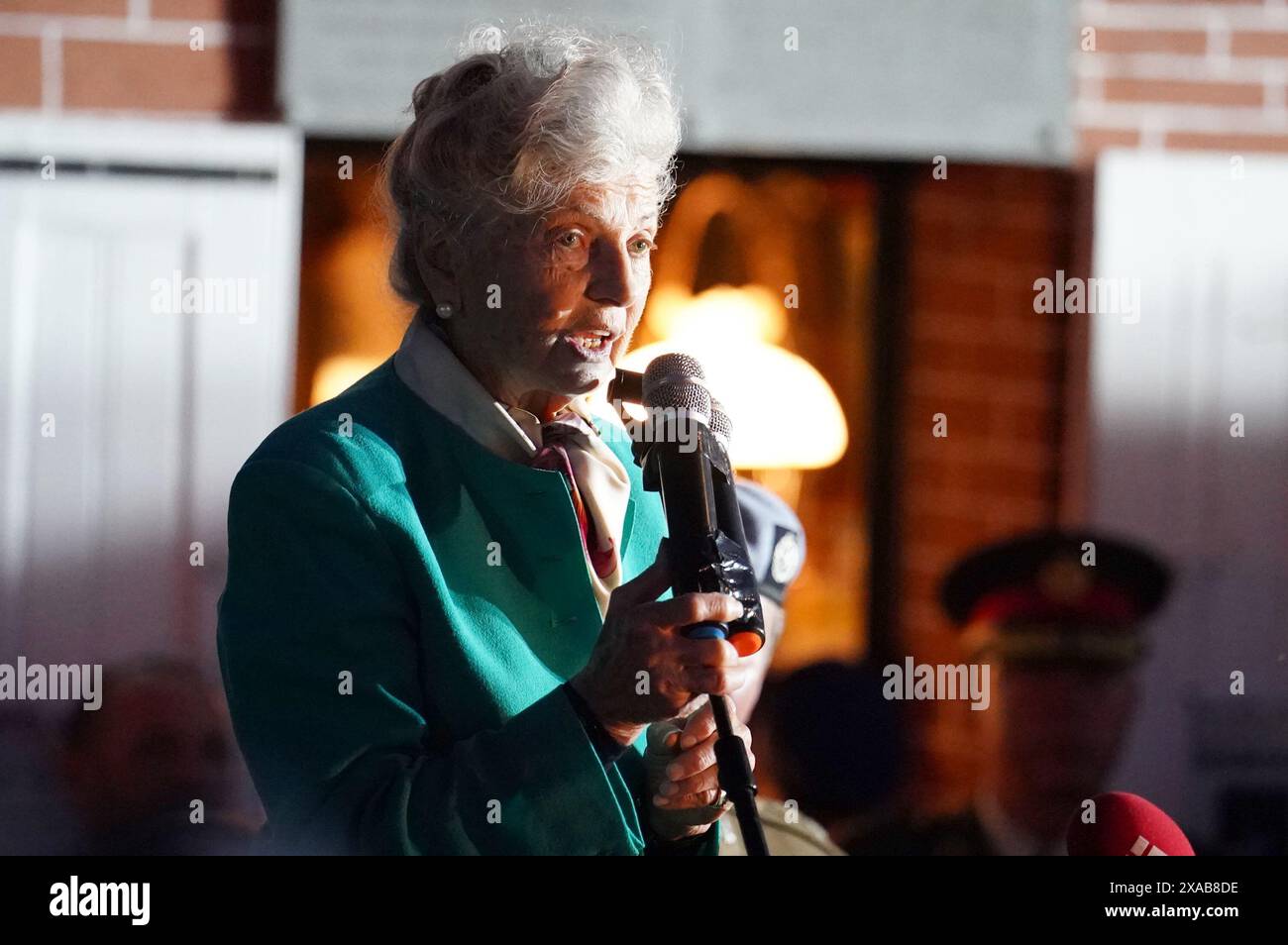 84-year-old Arlette Gondree speaking before giving a champagne toast to D-Day veterans at 2316 in the evening, marking the exact moment 80 years ago that British troops entered her family's cafe in Benouville, Normandy, France, making them the first family to be liberated from German control. Picture date: Wednesday June 5, 2024. Stock Photo