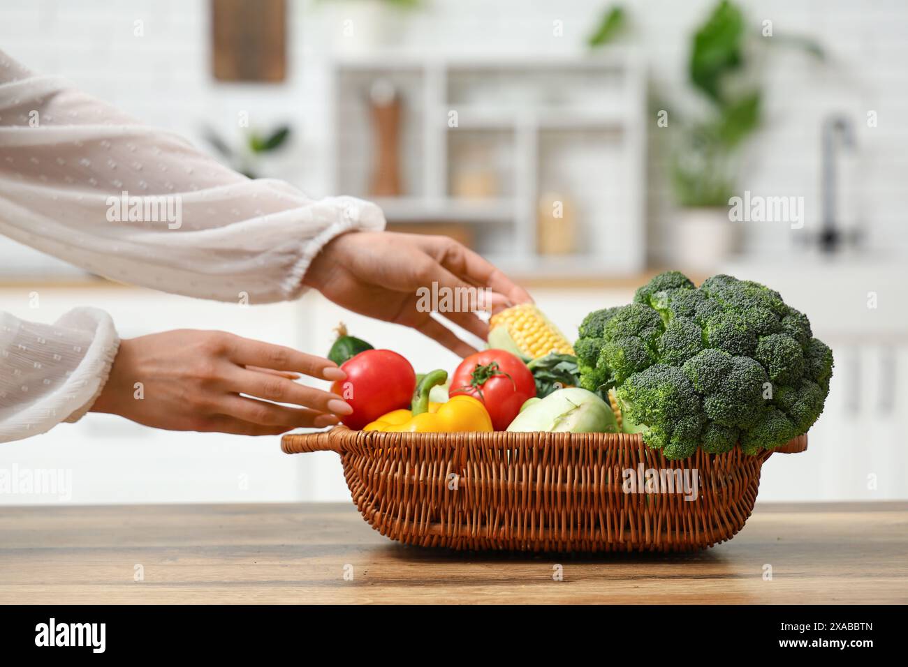 Pregnant woman holding wicker basket with different fresh vegetables in ...