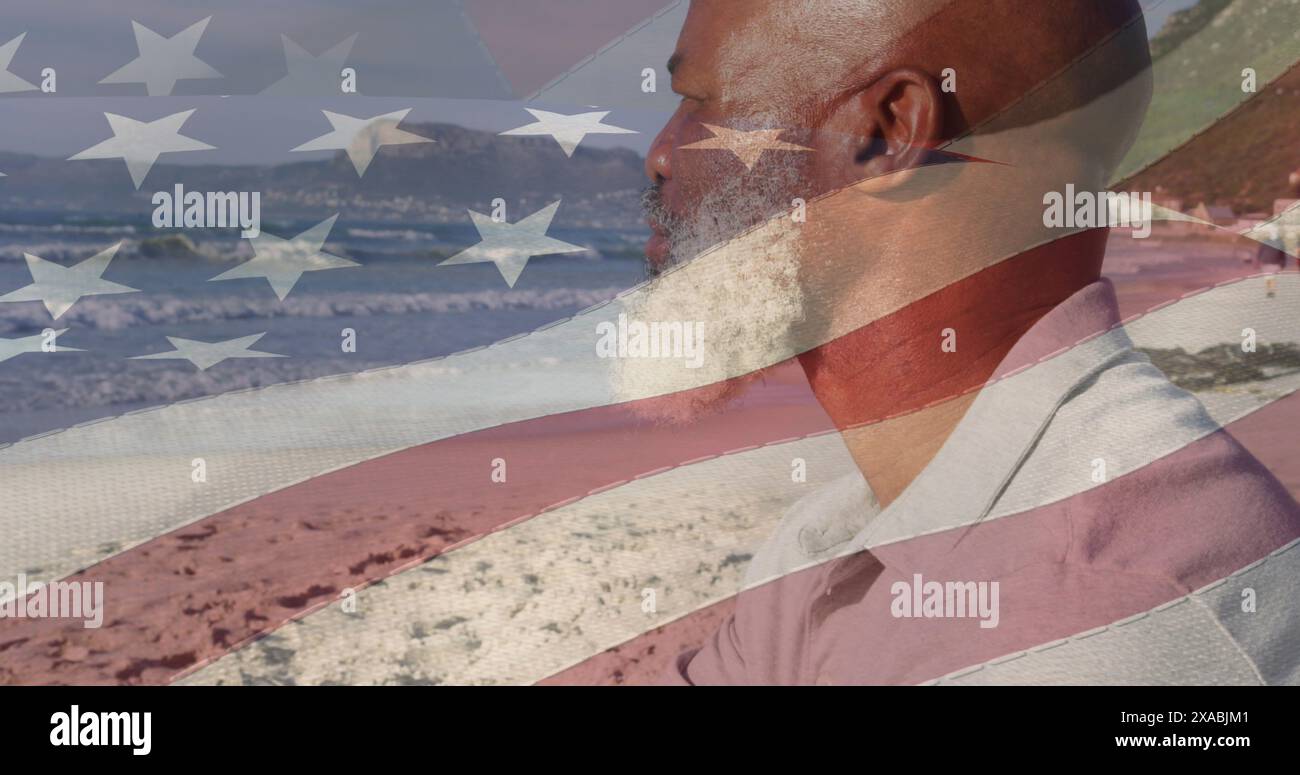 Image of flag of united states of america over senior african american man on beach Stock Photo