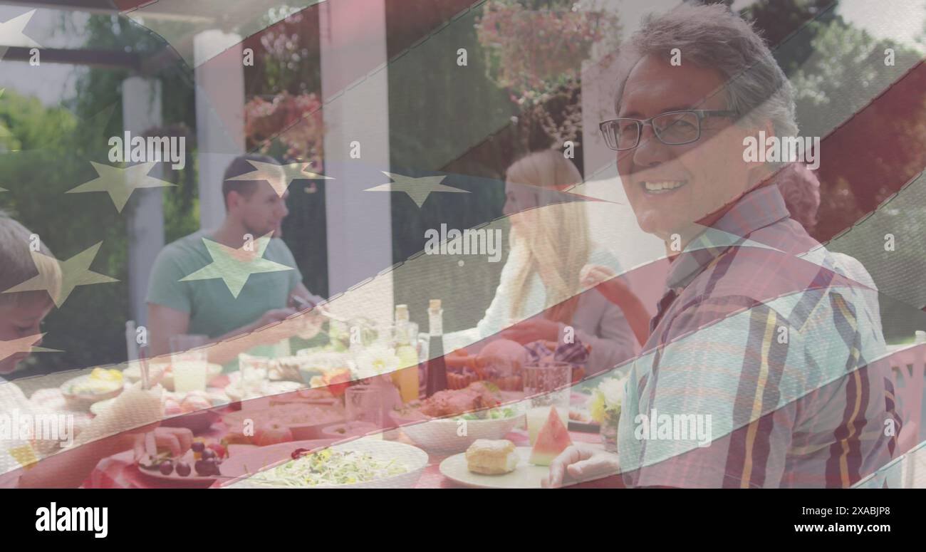 Image of american flag over happy caucasian family having dinner and smiling Stock Photo